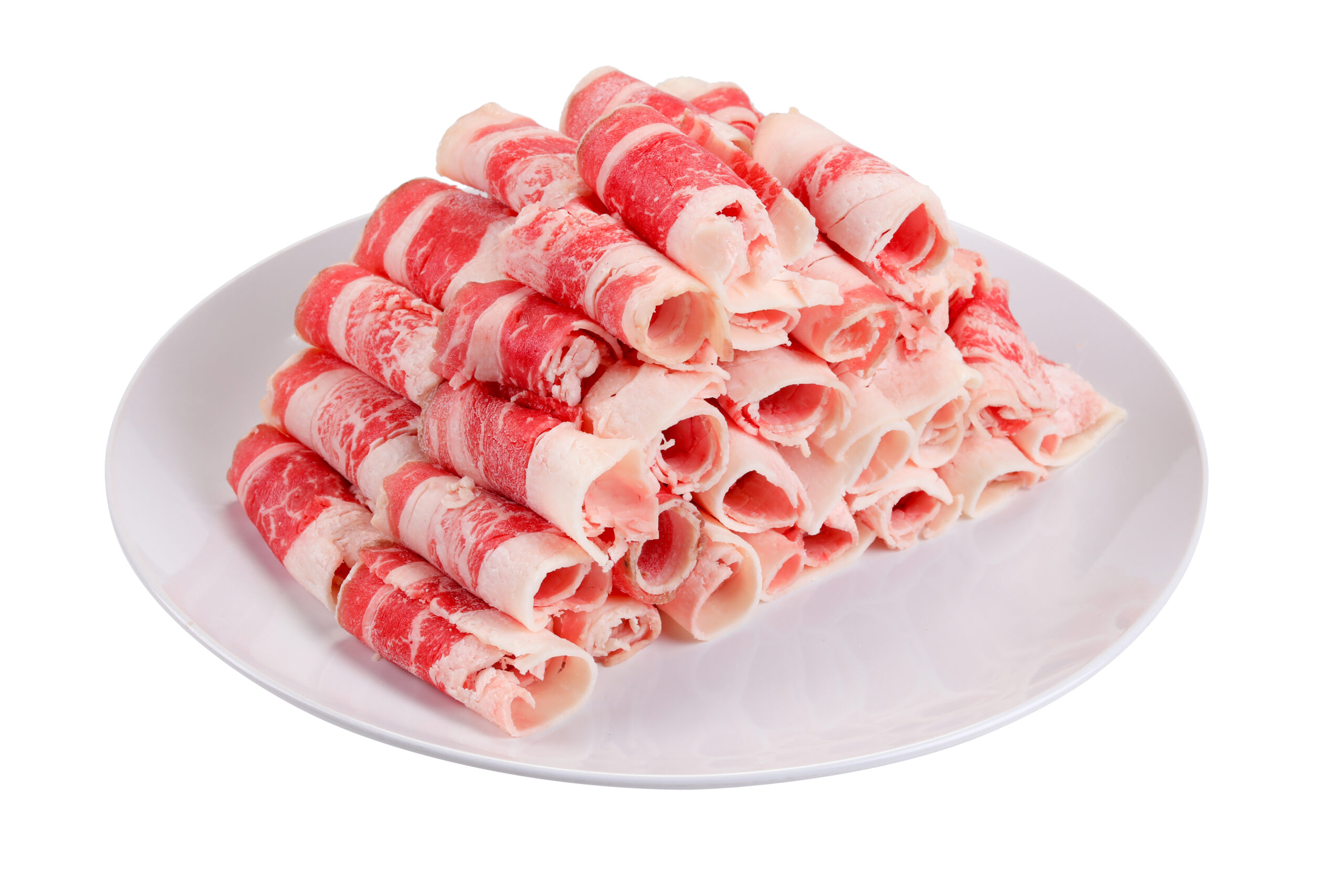 Thinly sliced beef rolls on a white platter